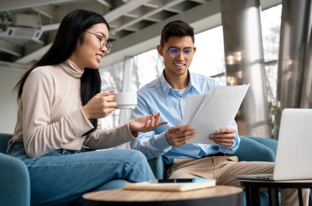 Teachers reviewing papers from international students