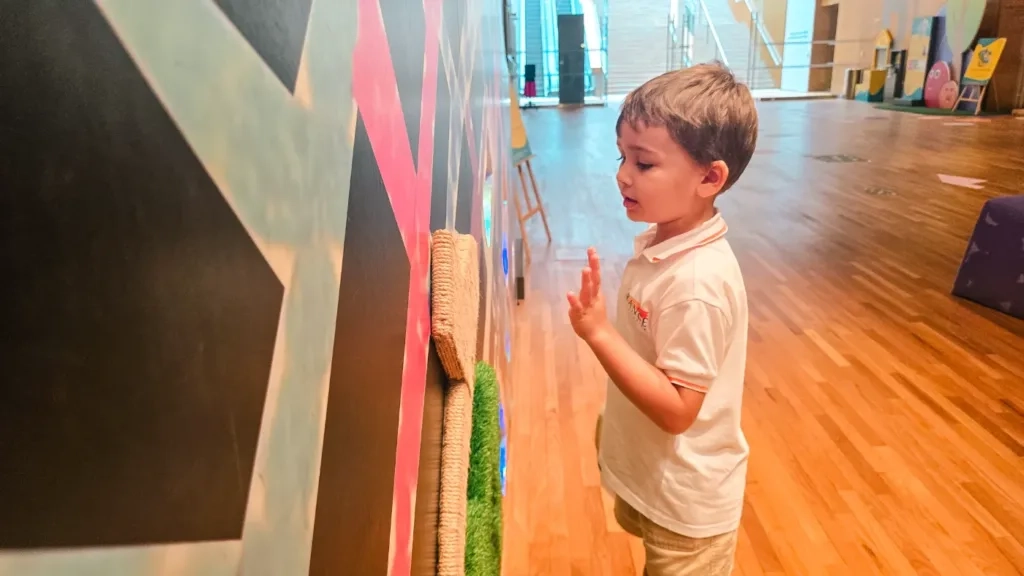 Preschooler from The Grange International Preschool interact with a tactile wall at the Gallery